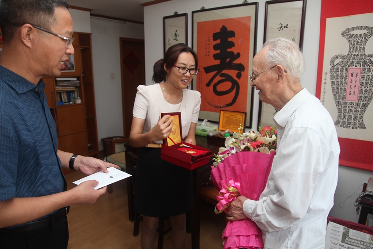 张苏皖书记向智仁勇老人介绍抗战胜利70周年纪念徽章